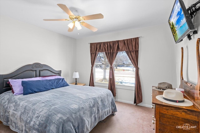 bedroom featuring baseboards, ceiling fan, and light colored carpet