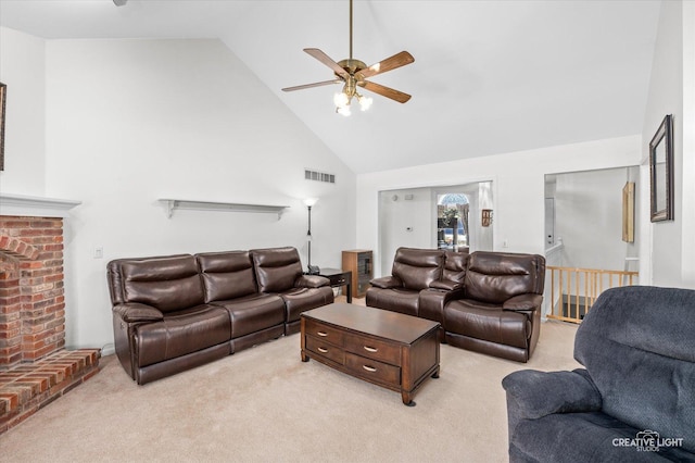 living room featuring a fireplace, visible vents, a ceiling fan, light carpet, and high vaulted ceiling