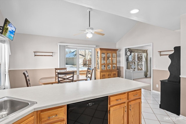 kitchen with lofted ceiling, light tile patterned flooring, a ceiling fan, light countertops, and dishwasher