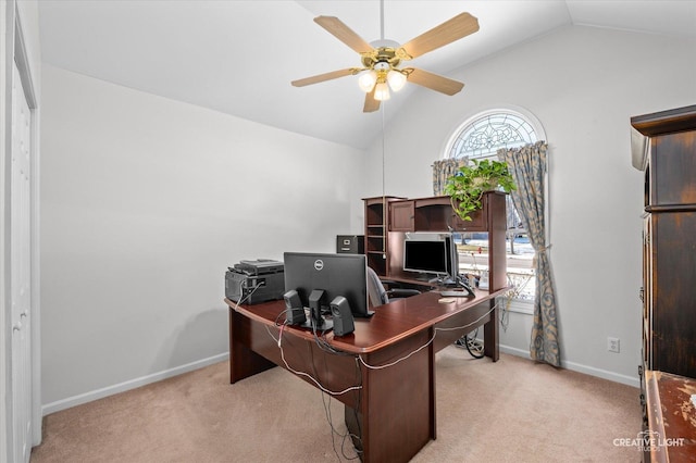 office with lofted ceiling, baseboards, a ceiling fan, and light colored carpet