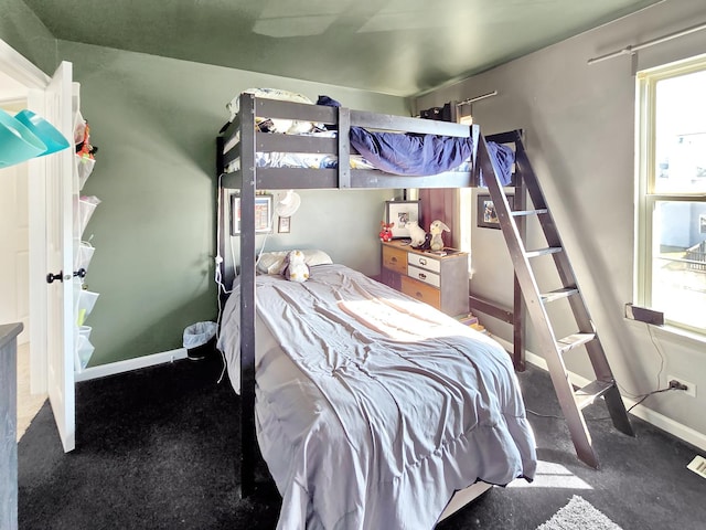 bedroom with multiple windows and baseboards