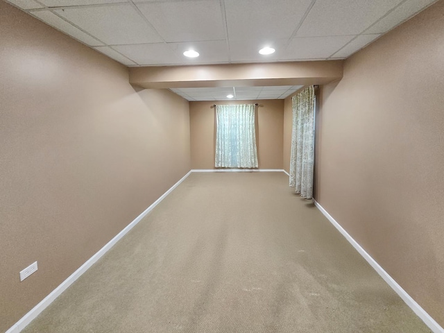 below grade area featuring recessed lighting, a drop ceiling, carpet flooring, and baseboards