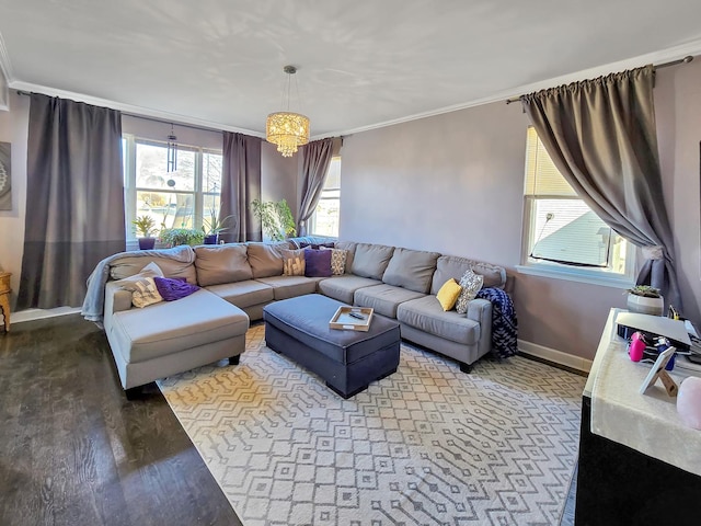 living area with crown molding, baseboards, and wood finished floors