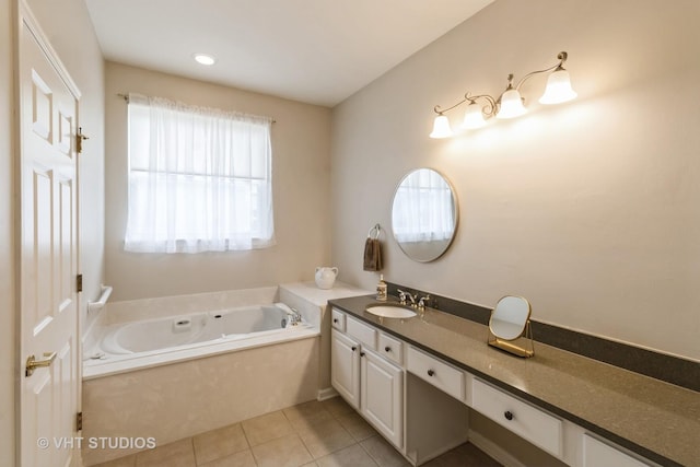 bathroom with a garden tub, vanity, and tile patterned floors