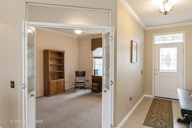 foyer entrance featuring light carpet, baseboards, and crown molding