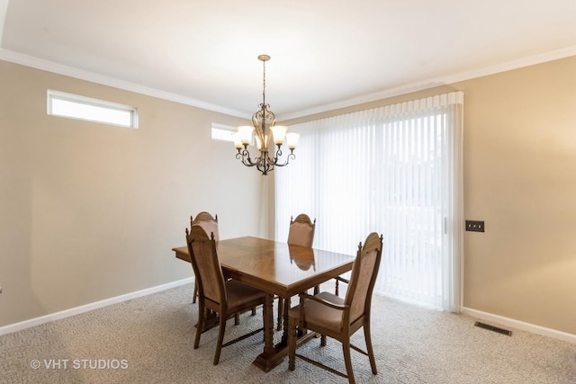 dining space featuring light colored carpet, visible vents, and crown molding