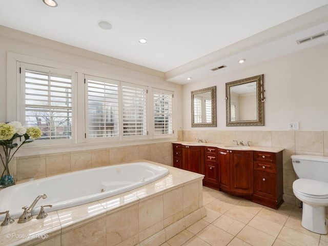 full bath featuring toilet, a wealth of natural light, a sink, and visible vents