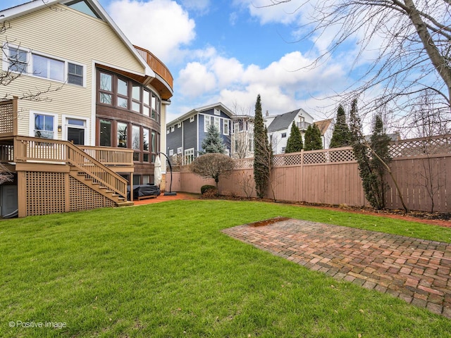 view of yard with a deck, stairway, a patio area, and a fenced backyard