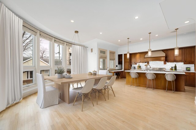 dining area with light wood-style floors and recessed lighting