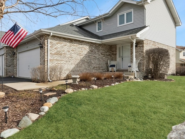 view of side of property featuring a yard, brick siding, an attached garage, and a shingled roof