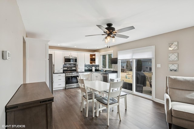 dining area featuring dark wood-style floors, baseboards, a ceiling fan, and recessed lighting