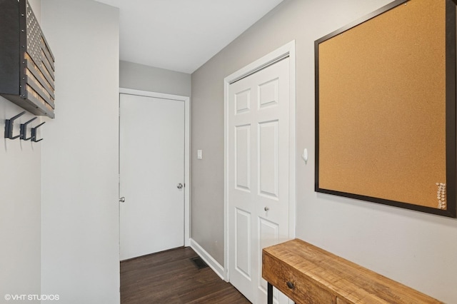 corridor featuring dark wood-type flooring