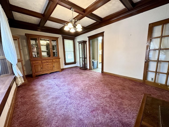 spare room featuring baseboards, coffered ceiling, beamed ceiling, an inviting chandelier, and dark carpet