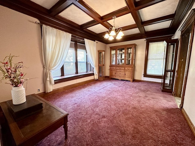 unfurnished living room featuring baseboards, coffered ceiling, beamed ceiling, dark carpet, and a notable chandelier