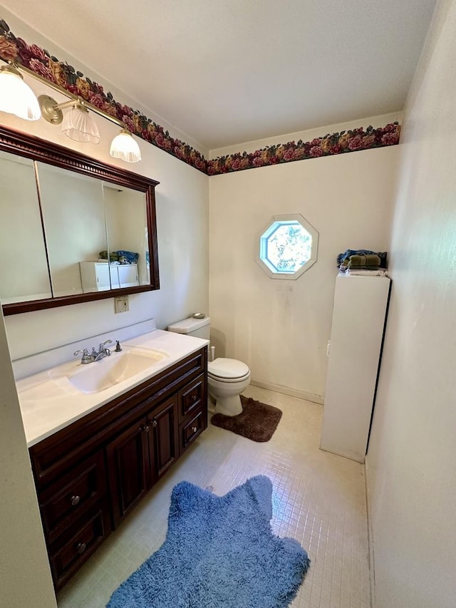 bathroom featuring toilet and vanity