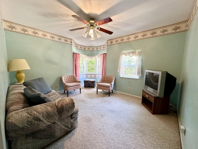 sitting room with ceiling fan, baseboards, and carpet flooring