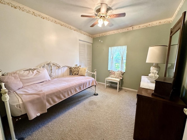 carpeted bedroom featuring a closet, baseboards, and a ceiling fan