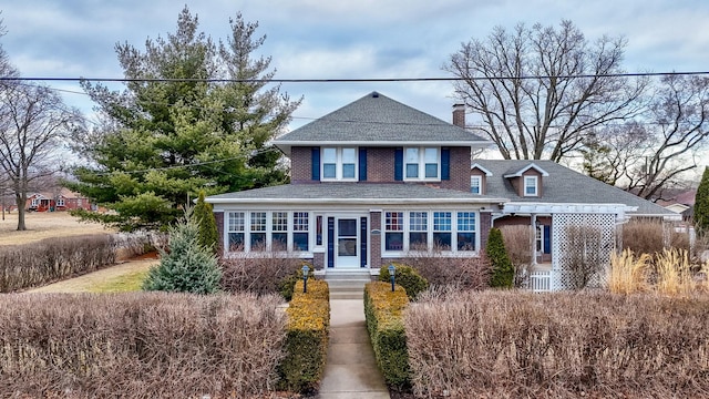 traditional-style home featuring brick siding and a chimney