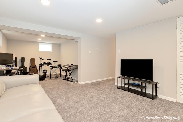 carpeted living area featuring baseboards, visible vents, and recessed lighting