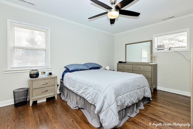 bedroom with visible vents, dark wood finished floors, and crown molding