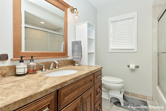 bathroom with toilet, vanity, baseboards, tile patterned floors, and a shower with door