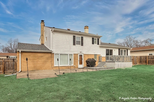 rear view of house featuring brick siding, a patio, a chimney, and a lawn