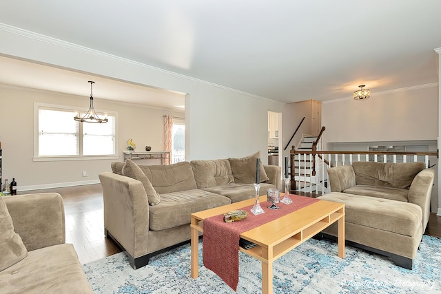 living room with baseboards, stairway, ornamental molding, wood finished floors, and a chandelier