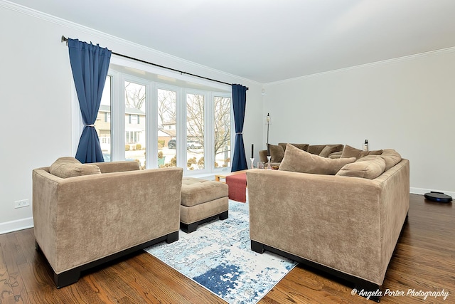 living room with dark wood-type flooring, crown molding, and baseboards