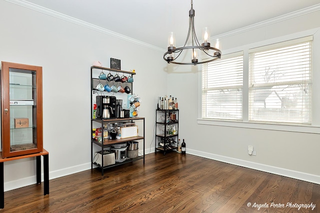 dining room with an inviting chandelier, baseboards, crown molding, and wood finished floors