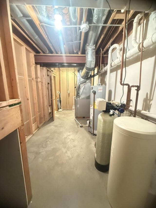 unfinished basement featuring water heater