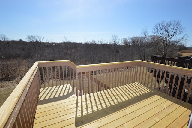 wooden deck with a view of trees