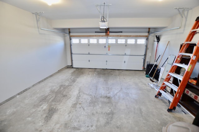 garage featuring a garage door opener and baseboards