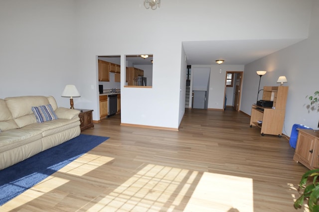 living room featuring light wood-type flooring and baseboards