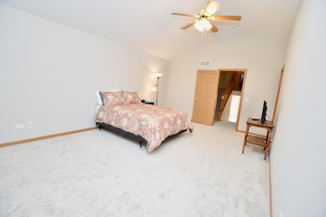 bedroom with visible vents, lofted ceiling, light colored carpet, and baseboards