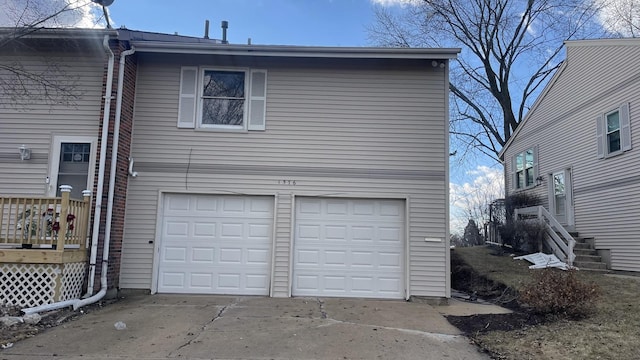 garage featuring concrete driveway