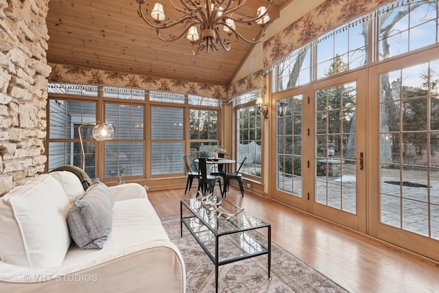 sunroom / solarium featuring a chandelier, lofted ceiling, and wooden ceiling