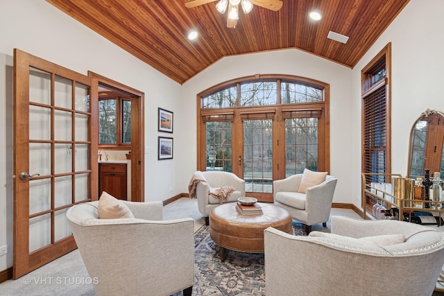 living area featuring french doors, lofted ceiling, wood ceiling, carpet flooring, and baseboards