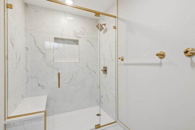 full bathroom featuring a marble finish shower