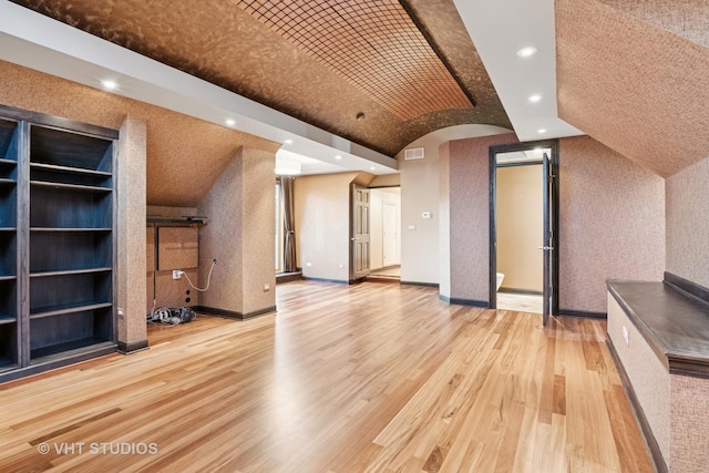 bonus room featuring light wood-type flooring, lofted ceiling, baseboards, and recessed lighting