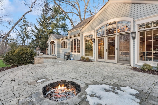 view of patio / terrace with a grill and a fire pit