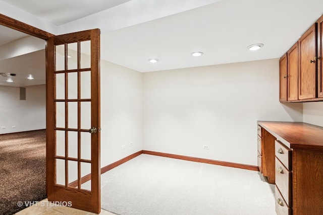 interior space with brown cabinets, recessed lighting, light countertops, light carpet, and baseboards