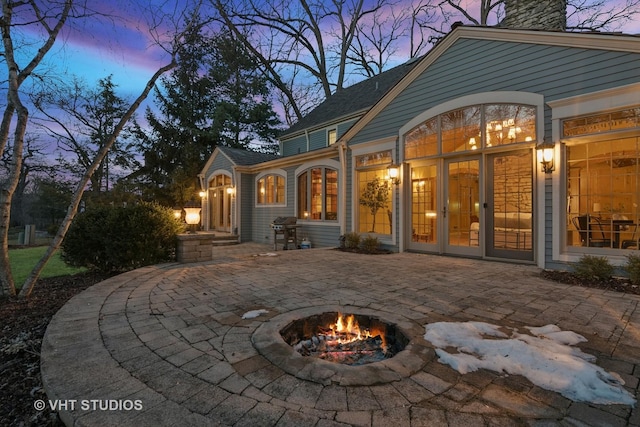 back of house with a patio area, a chimney, and a fire pit