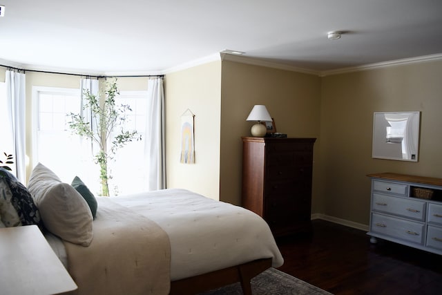 bedroom featuring baseboards, visible vents, ornamental molding, and dark wood-type flooring