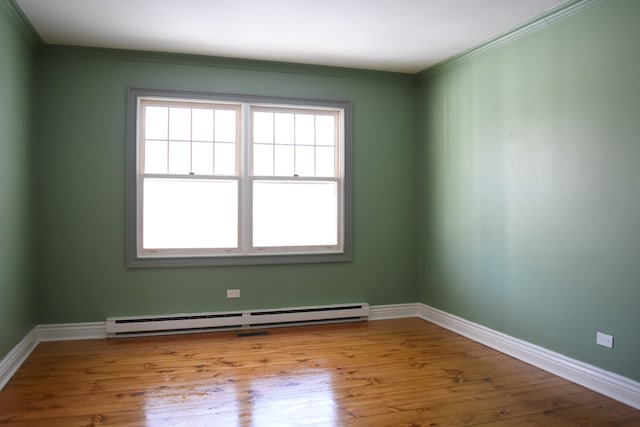 spare room with plenty of natural light, light wood finished floors, a baseboard radiator, and baseboards