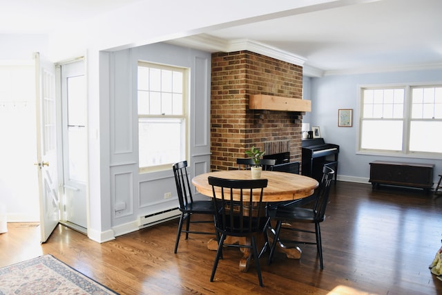 dining space featuring dark wood-style floors, baseboards, ornamental molding, and baseboard heating