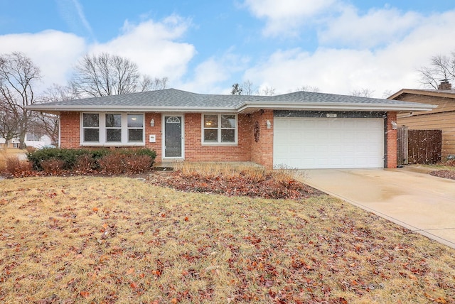 single story home with a front lawn, driveway, a shingled roof, a garage, and brick siding