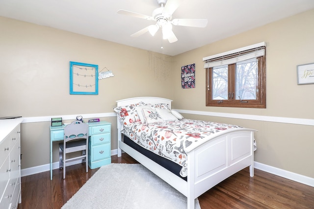 bedroom with a ceiling fan, wood finished floors, and baseboards