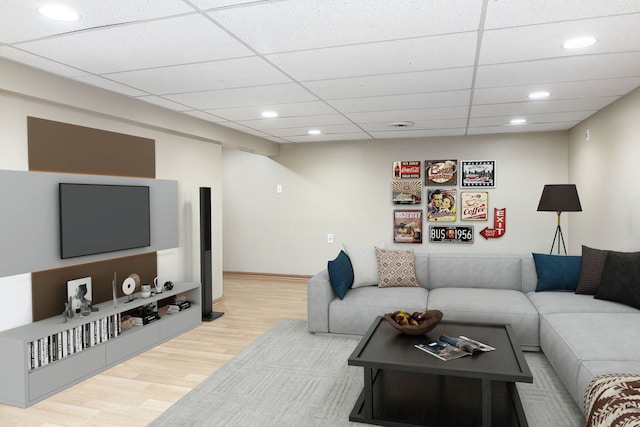 living area with recessed lighting, a paneled ceiling, baseboards, and wood finished floors