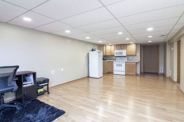 kitchen with recessed lighting, white appliances, light wood-style floors, light countertops, and baseboards