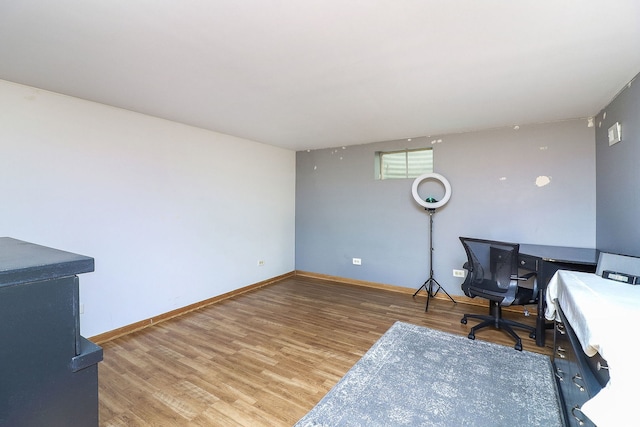 office featuring baseboards and light wood finished floors